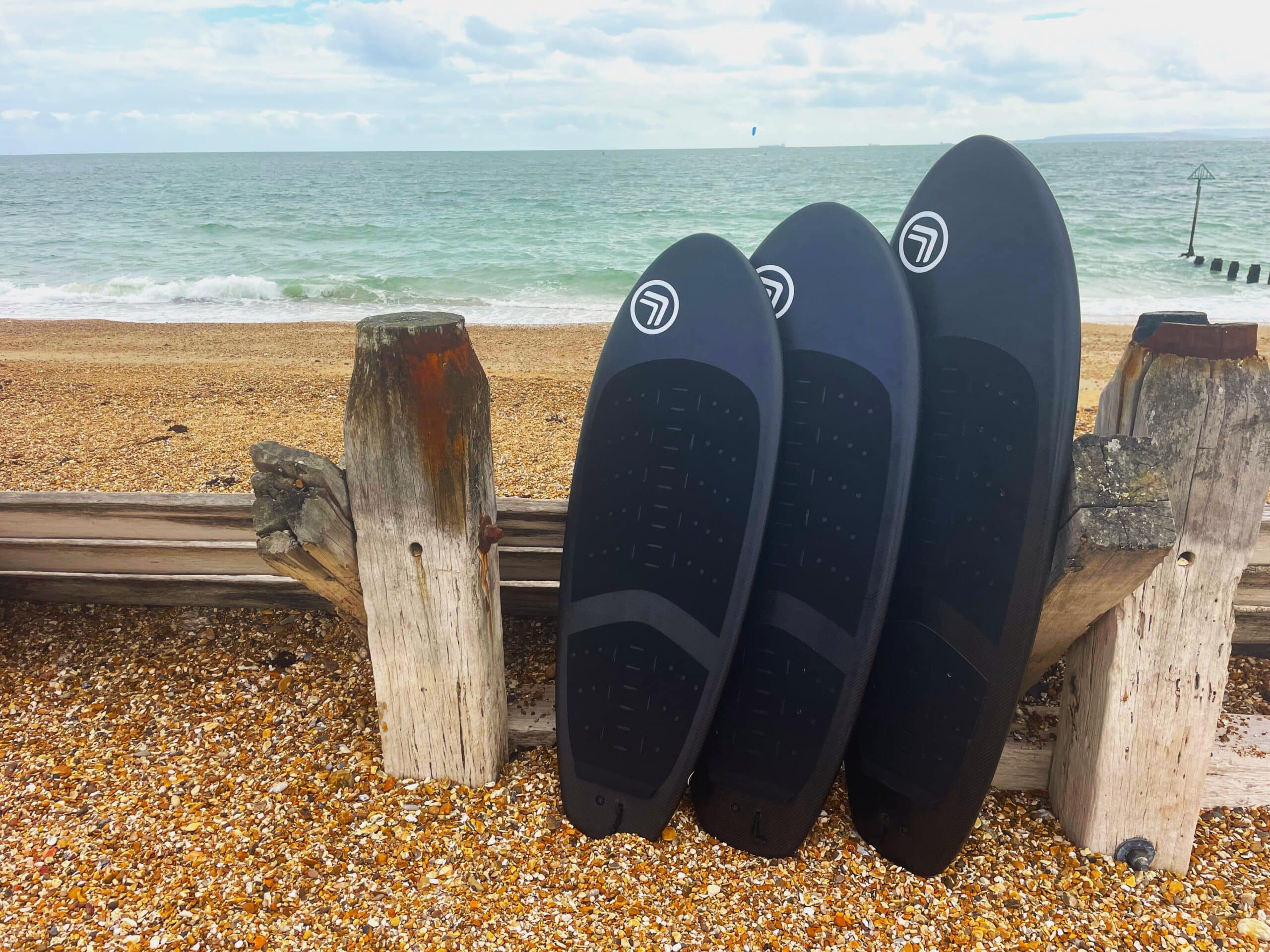 3 PR prone surf foil boards on display on the beach